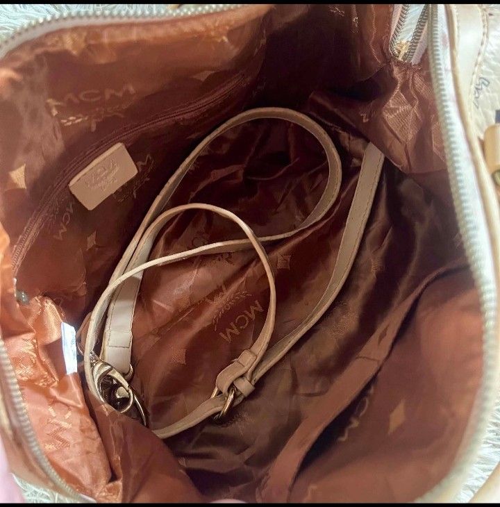 MCM Monogram Boston Bag korea (Category: Luxury Bags & Wallets) located in Caloocan City. Submitted by noy5o1a (Listing ID 1448997565, Image 3). Description: - Classic MCM monogram Boston bag - Color: Beige with navy blue MCM pattern - Material: Leather handles and trim - Interior: Zip pocket and detachable strap - Spacious design, ideal for everyday use -mcm korea.