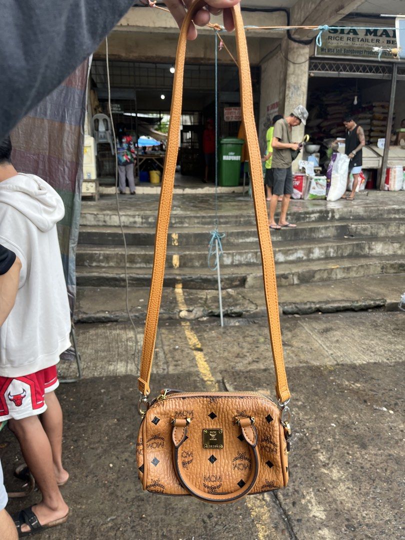 MCM Monogram Mini Boston Bag (Category: Luxury Bags & Wallets) located in Pontevedra. Submitted by thrift01 (Listing ID 1448943506, Image 3). Description: - Cute MCM mini Boston bag - Classic all-over monogram print - Detachable strap for shoulder or crossbody wear - Elegant gold hardware details - Interior tag indicates 'Made in Korea' - Ideal for carrying your daily essentials.