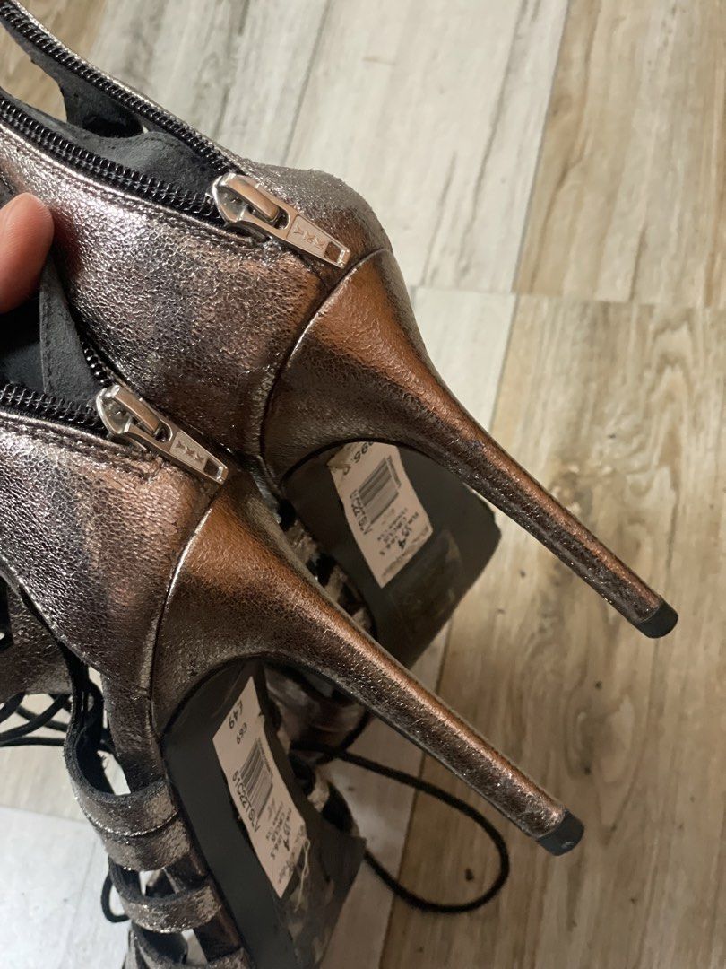 Metallic Lace-Up Gladiator Heels (Category: Heels) located in Taytay. Submitted by chenpots (Listing ID 1448939135, Image 3). Description: - Metallic gladiator heels by Miss Selfridge - Shimmery bronze or rose gold color - Size: 37 EU / 6.5 US - Features lace-up front and back zippers - Perfect for elevating any outfit - Minor scuffs on the inside sole.