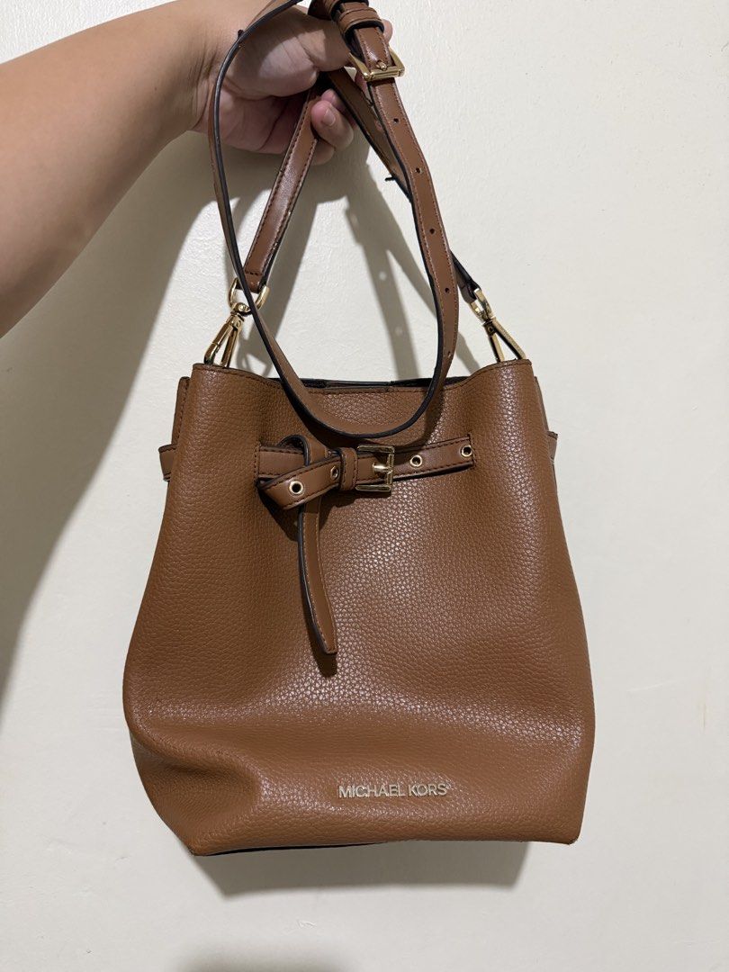 Michael Kors Emilia Bucket Bag (Category: Luxury Bags & Wallets) located in Makati City. Submitted by gkp14 (Listing ID 1449020256, Image 1). Description: - Brand: Michael Kors - Material: Brown pebbled leather - Style: Bucket bag - Strap: Adjustable crossbody strap - Hardware: Gold details - Ideal for: Everyday use.