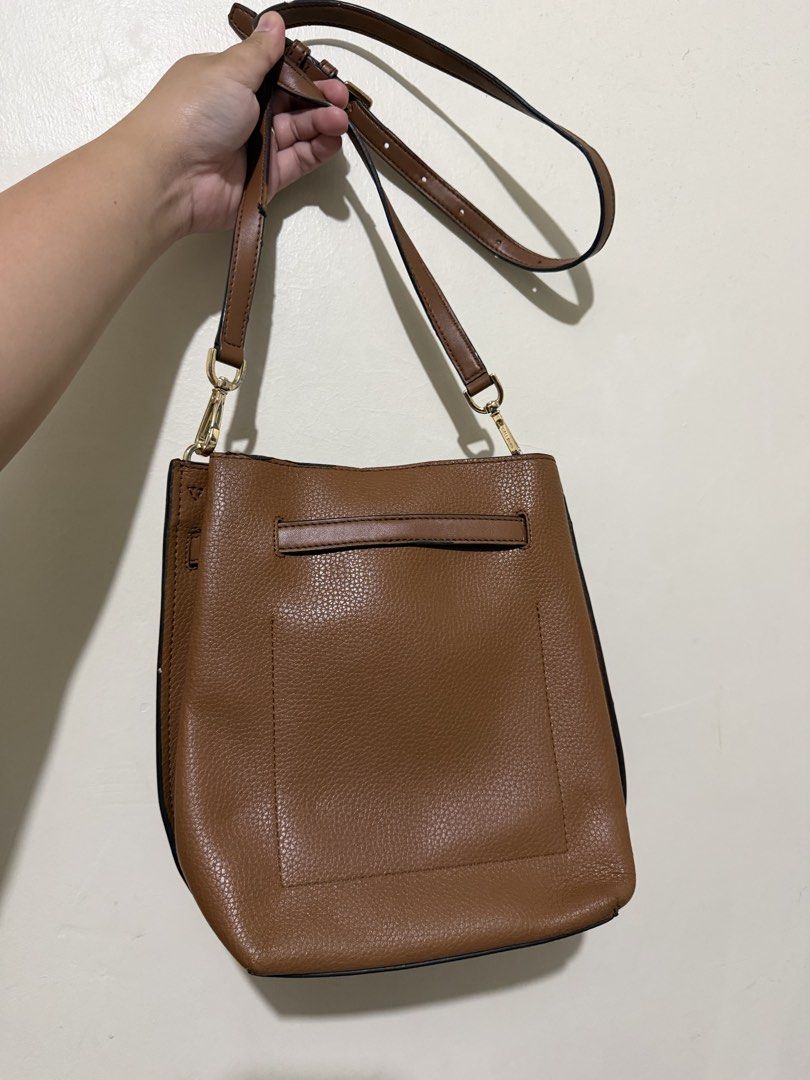 Michael Kors Emilia Bucket Bag (Category: Luxury Bags & Wallets) located in Makati City. Submitted by gkp14 (Listing ID 1449020256, Image 2). Description: - Brand: Michael Kors - Material: Brown pebbled leather - Style: Bucket bag - Strap: Adjustable crossbody strap - Hardware: Gold details - Ideal for: Everyday use.