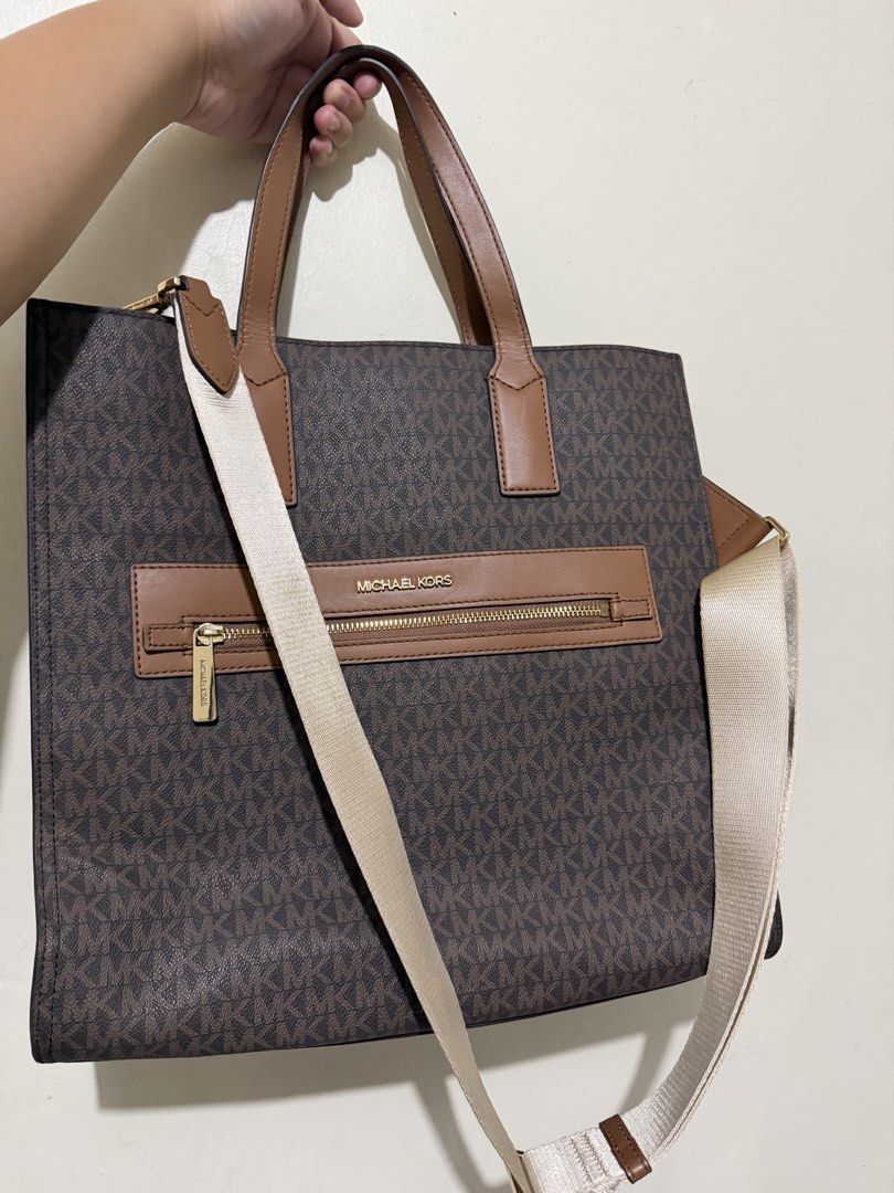 Michael Kors Kenly Tote Bag with Strap (Category: Luxury Bags & Wallets) located in Makati City. Submitted by gkp14 (Listing ID 1449020859, Image 1). Description: - Authentic Michael Kors tote bag - Classic brown MK monogram print - Tan leather trim and handles - Gold hardware details - Front zip pocket for easy access - Spacious interior for daily essentials - Includes a detachable crossbody strap.