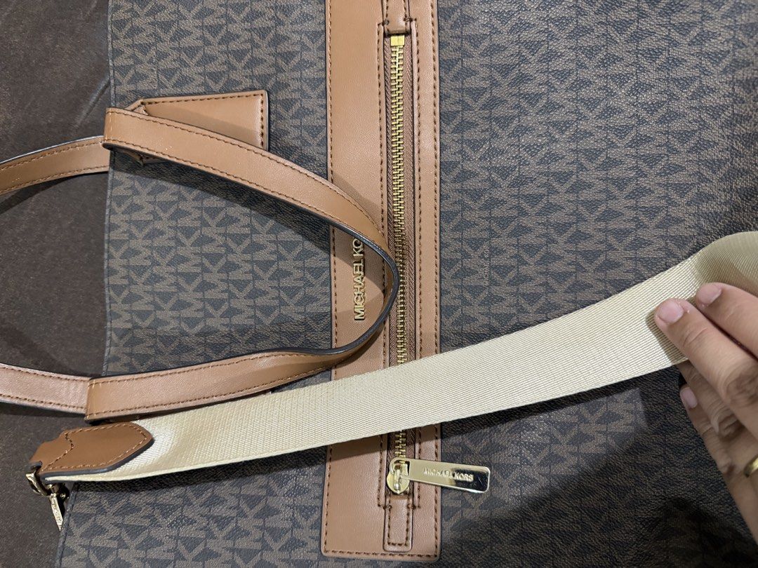 Michael Kors Kenly Tote Bag with Strap (Category: Luxury Bags & Wallets) located in Makati City. Submitted by gkp14 (Listing ID 1449020859, Image 3). Description: - Authentic Michael Kors tote bag - Classic brown MK monogram print - Tan leather trim and handles - Gold hardware details - Front zip pocket for easy access - Spacious interior for daily essentials - Includes a detachable crossbody strap.