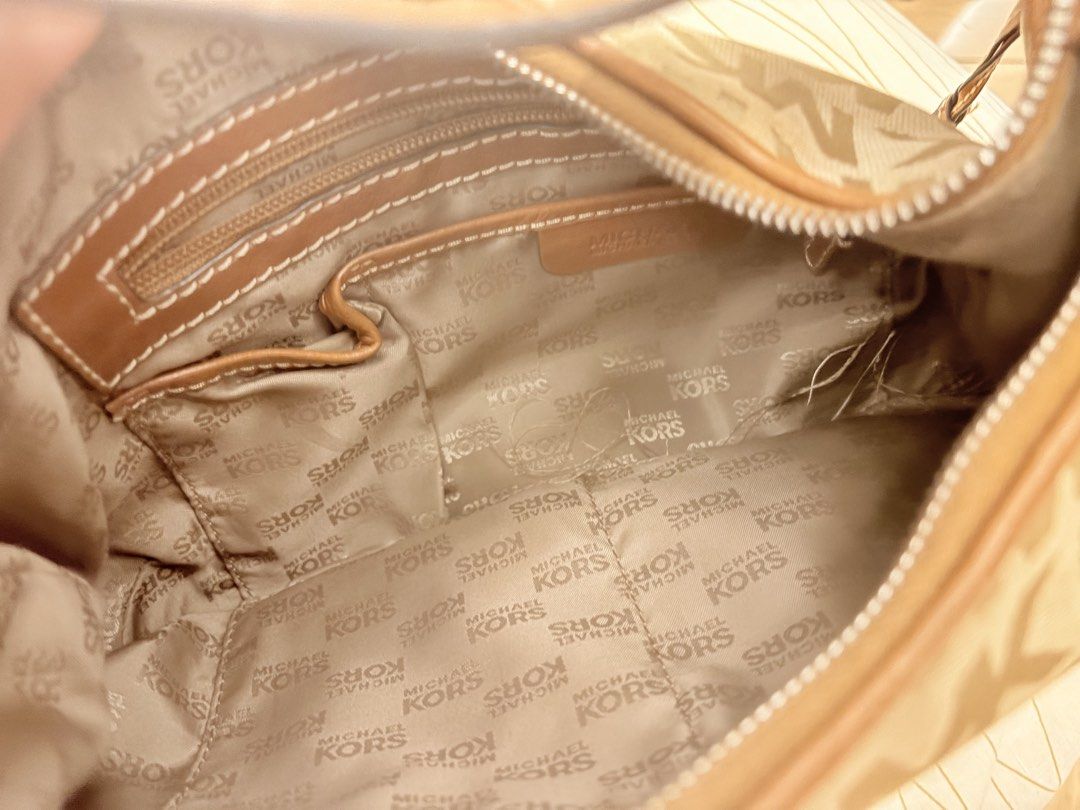 Michael Kors Shoulder Bag (Category: Luxury Bags & Wallets) located in Cainta. Submitted by Hobbyduck_Shop (Listing ID 1449039560, Image 3). Description: - Authentic Michael Kors hobo bag - Beige canvas with signature MK monogram print - Brown leather trim and strap - Silver MK logo charm accent - Interior zip and slip pockets for organization - Ideal everyday bag.