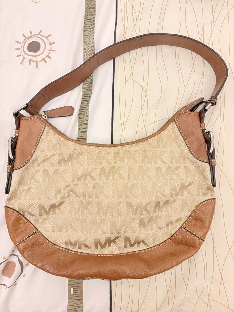 Michael Kors Shoulder Bag (Category: Luxury Bags & Wallets) located in Cainta. Submitted by Hobbyduck_Shop (Listing ID 1449039560, Image 2). Description: - Authentic Michael Kors hobo bag - Beige canvas with signature MK monogram print - Brown leather trim and strap - Silver MK logo charm accent - Interior zip and slip pockets for organization - Ideal everyday bag.