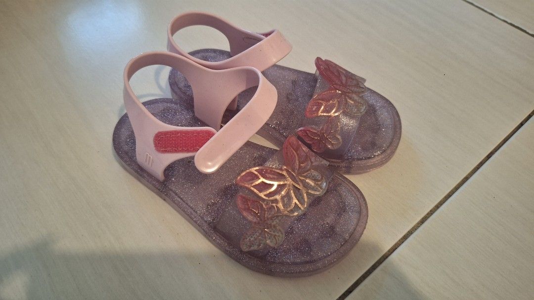 Mini Melissa Glitter Butterfly Jelly Sandals (Category: Babies & Kids Fashion) located in Manila. Submitted by katrinepet63113 (Listing ID 1448898736, Image 2). Description: - Cute Mini Melissa jelly sandals for kids - Features sparkly glitter and butterfly details - Pink straps with easy velcro closure - Durable soles with good grip - Perfect for playtime and everyday wear.