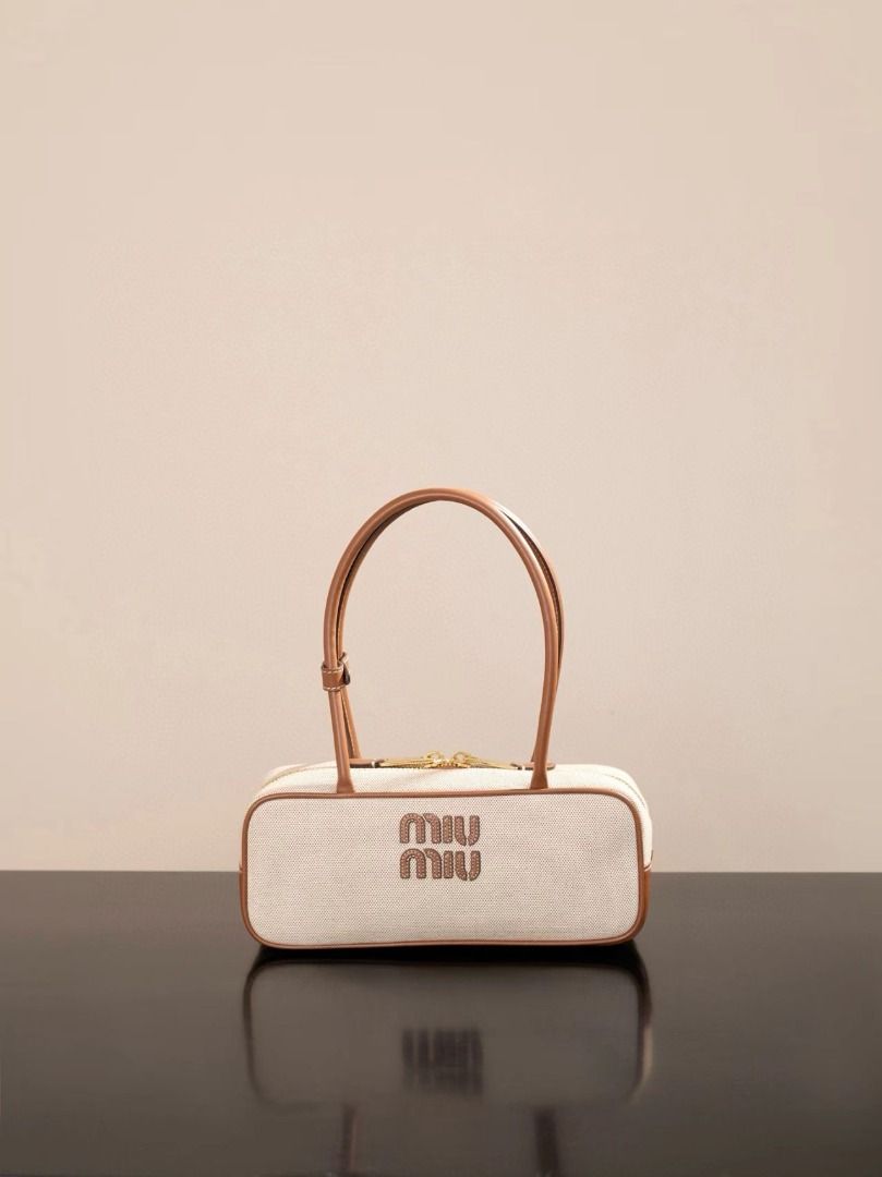 Miu Miu Canvas & Leather Boston Bag (Category: Luxury Bags & Wallets) located in Pateros City. Submitted by rmzekolora80602 (Listing ID 1448918109, Image 1). Description: - Cream canvas with brown leather trim - Classic Miu Miu logo on the front - Secure zipper closure - Comfortable top handles - Chic and versatile design - Ideal for daily use.
