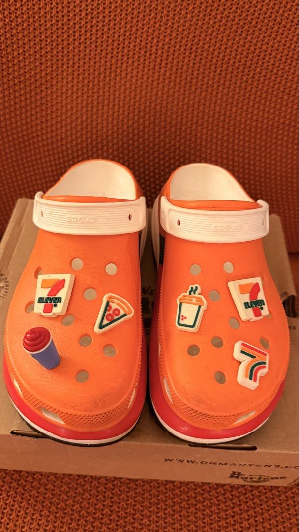 Orange Crocs with 7-Eleven Jibbitz Charms (Category: Slippers & Slides) located in Pasig City. Submitted by igibernabe (Listing ID 1449006425, Image 1). Description: - Super fun orange Crocs - Decorated with 7-Eleven jibbitz charms - Includes pizza, drink, and 7-Eleven logo charms - Unique pair for any fan - Great for casual wear.