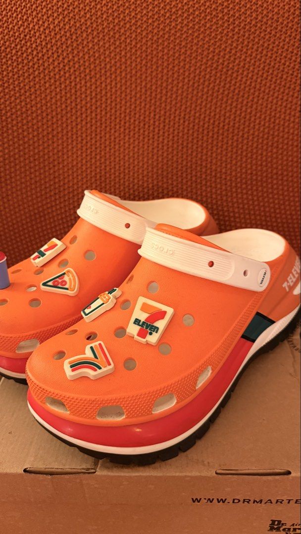 Orange Crocs with 7-Eleven Jibbitz Charms (Category: Slippers & Slides) located in Pasig City. Submitted by igibernabe (Listing ID 1449006425, Image 3). Description: - Super fun orange Crocs - Decorated with 7-Eleven jibbitz charms - Includes pizza, drink, and 7-Eleven logo charms - Unique pair for any fan - Great for casual wear.