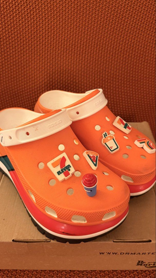 Orange Crocs with 7-Eleven Jibbitz Charms (Category: Slippers & Slides) located in Pasig City. Submitted by igibernabe (Listing ID 1449006425, Image 2). Description: - Super fun orange Crocs - Decorated with 7-Eleven jibbitz charms - Includes pizza, drink, and 7-Eleven logo charms - Unique pair for any fan - Great for casual wear.