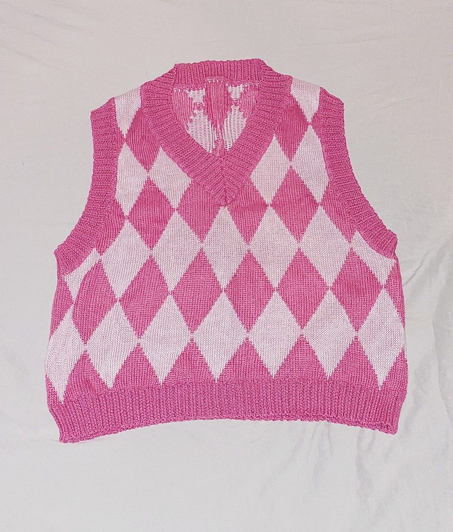 Pink and White Argyle Knit V-Neck Vest (Category: Sleeveless) located in Rizal. Submitted by mariririe (Listing ID 1448904882, Image 1). Description: Helping sister declutter! - Cute pink and white argyle knit vest - V-neck design - Sleeveless - Ideal for layering over shirts or dresses - Adds a pop of color - Soft and comfortable material.