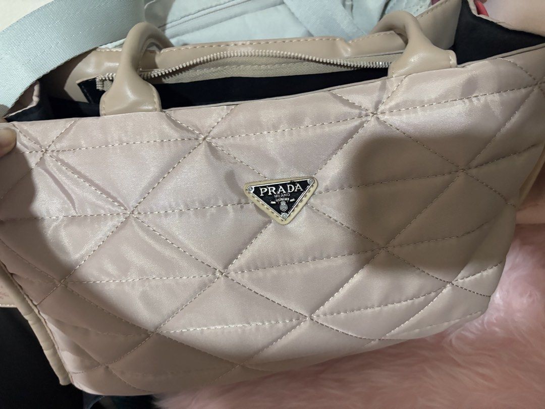 Prada Nylon Tote Bag (Category: Luxury Bags & Wallets) located in Manila. Submitted by beng.2625 (Listing ID 1449100707, Image 1). Description: - Light pink Prada shoulder bag - Classic Prada triangle logo - Durable quilted nylon material - Secure zipper closure - Comfortable shoulder straps - Ideal for everyday use.