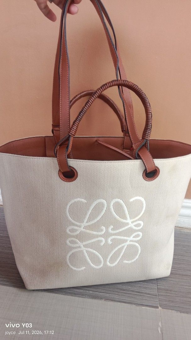 Preloved Loewe Anagram Canvas Tote Bag (Category: Luxury Bags & Wallets) located in Cabuyao City. Submitted by selections888 (Listing ID 1449089306, Image 1). Description: -preloved from Japan supplier - Loewe Anagram Tote Bag - Color: off white canvas with brown leather trim and handles - Interior: Tan color - Features: Woven detail on handles, ample space - Ideal for: Everyday use, travel -with made and serial -llarge size -expect signs of use 