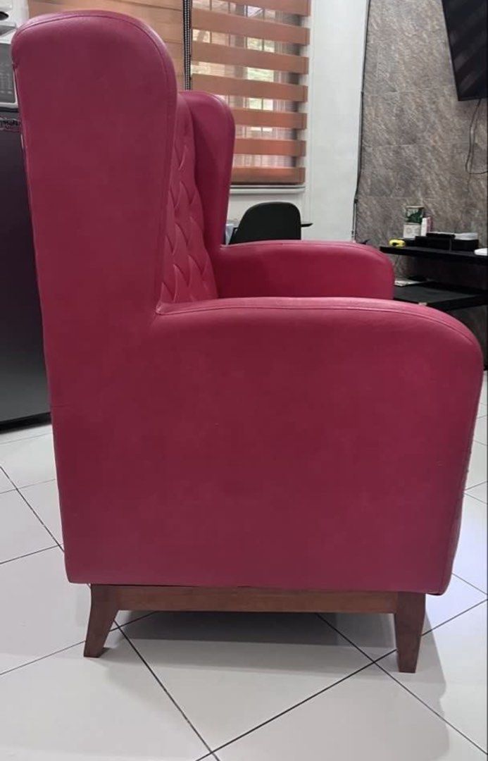 Red Tufted Wingback Sofa Chair (Category: Sofas) located in Cavite. Submitted by z3113 (Listing ID 1448972609, Image 3). Description: - Classic red armchair with elegant tufted backrest. - Shiny red upholstery for a striking look. - Sturdy wooden legs for support. - Ideal as a statement accent piece for any room. - Approximately 2 feet wide..