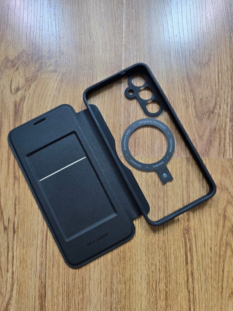 S24 Plus Flip Leather Magsafe Case (Category: Cases & Sleeves) located in Quezon City. Submitted by ecolutionph (Listing ID 1449045962, Image 2). Description: Authentic Duxducis Phone Case - Samsung S24 Plus - Black leather flip case - With adjustable magnetic stand - With card slot - Condition: new, never been used - Reason for selling: wrong phone model - Original price: P1000 - Selling price: P800 Loc: White Plains, QC.
