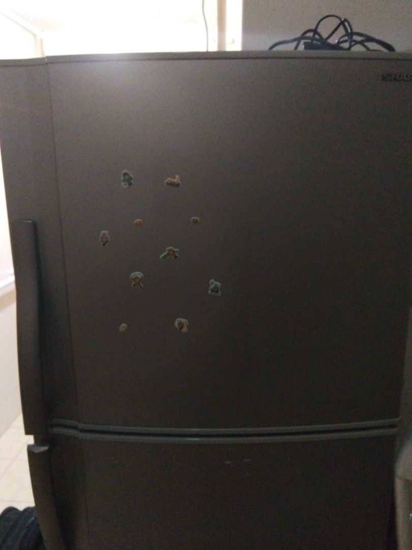 Sharp Refrigerator (Category: Refrigerators & Freezers) located in Singapore. Submitted by safedolphin.f2fe72 (Listing ID 1449059986, Image 2). Description: - Sharp refrigerator with top freezer - Still cools effectively - Ideal for dorm rooms or small apartments.