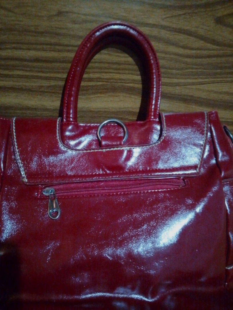 Shiny Red Handbag with Zipper Compartment (Category: Luxury Bags & Wallets) located in Caloocan City. Submitted by cleverrabbit (Listing ID 1448913024, Image 2). Description: - Red patent leather handbag - Main zipper compartment inside - Sturdy top handles - Clean interior - Perfect for everyday use (big).