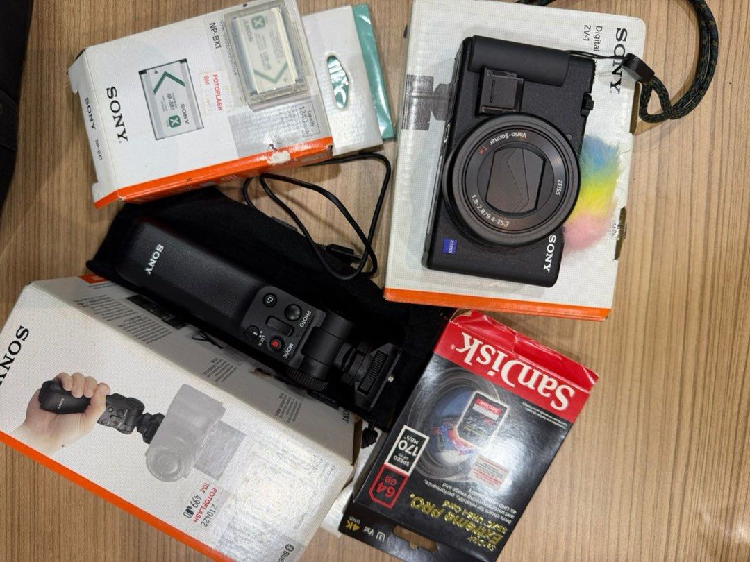 Sony ZV-1 Digital Camera Bundle with Accessories (Category: Cameras) located in Kuala Lumpur. Submitted by afiqdarwis27142 (Listing ID 1449092406, Image 2). Description: - Sony ZV-1 digital camera - VCT-SGR1 shooting grip included - NP-BX1 battery - 64GB SanDisk Extreme Pro SD card - Original boxes - Camera pouch - Ideal for vlogging and content creation.