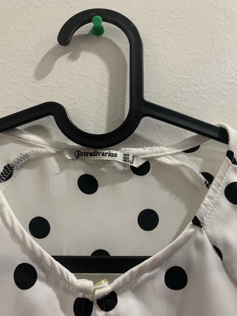 Stradivarius White Black Polka Dot Tie Front Blouse (Category: Blouses) located in Manila. Submitted by gracefilledshop (Listing ID 1448935164, Image 2). Description: - White long-sleeved blouse - Classic black polka dot pattern - Flattering tie-front detail at the waist - Button cuffs for a polished look - Elegant keyhole opening at the neckline - Versatile for dressing up or down.