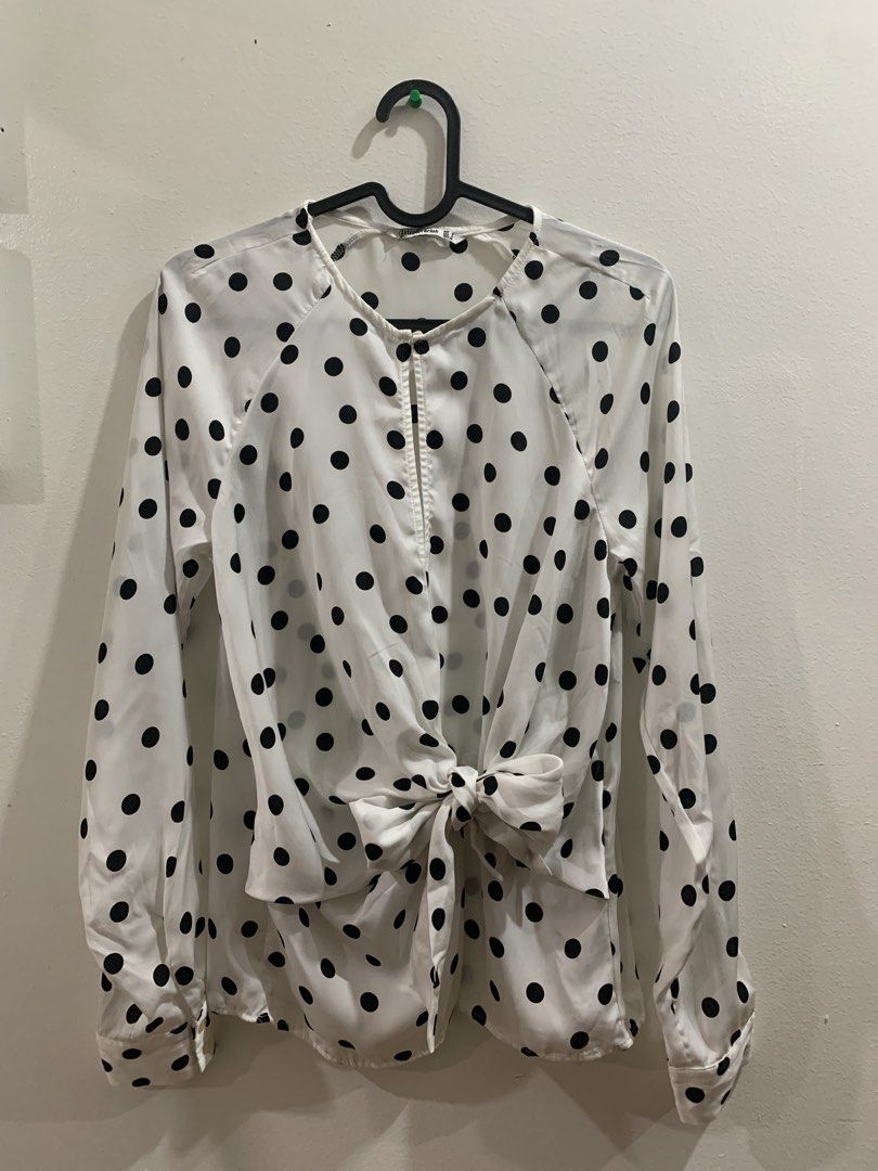 Stradivarius White Black Polka Dot Tie Front Blouse (Category: Blouses) located in Manila. Submitted by gracefilledshop (Listing ID 1448935164, Image 1). Description: - White long-sleeved blouse - Classic black polka dot pattern - Flattering tie-front detail at the waist - Button cuffs for a polished look - Elegant keyhole opening at the neckline - Versatile for dressing up or down.