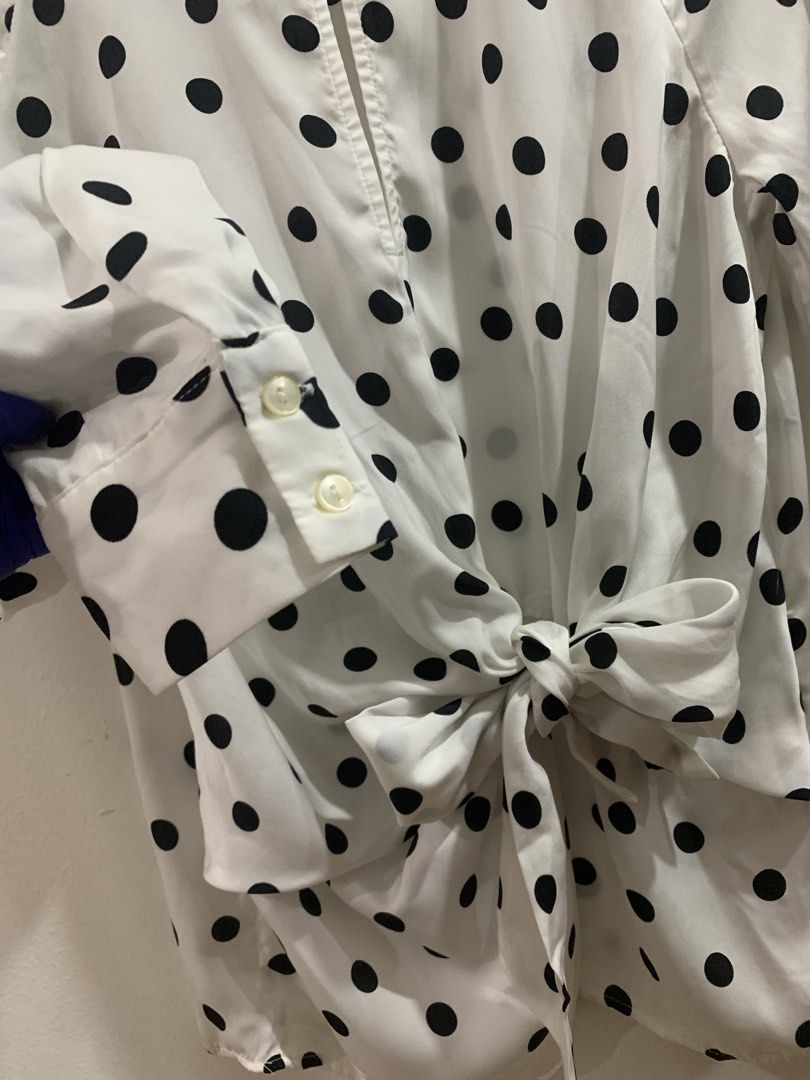 Stradivarius White Black Polka Dot Tie Front Blouse (Category: Blouses) located in Manila. Submitted by gracefilledshop (Listing ID 1448935164, Image 3). Description: - White long-sleeved blouse - Classic black polka dot pattern - Flattering tie-front detail at the waist - Button cuffs for a polished look - Elegant keyhole opening at the neckline - Versatile for dressing up or down.