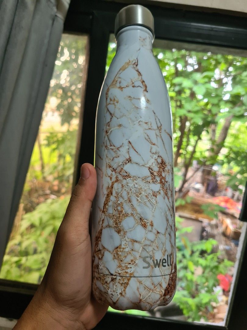 S'well Marble Water Bottle (Category: Water Bottles & Tumblers) located in Manila. Submitted by sevyaleinad (Listing ID 1448913265, Image 1). Description: - Stylish S'well water bottle with a chic marble design. - Features a sleek silver cap. - Excellent for maintaining drink temperature (hot or cold). - Convenient size for on-the-go use. - Showcases the iconic S'well logo. - Ideal for daily hydration needs..