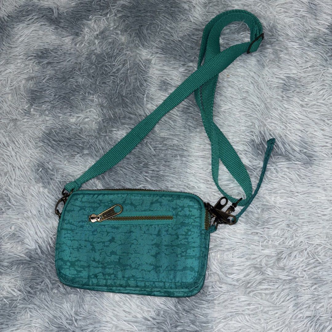 Teal Kipling Crossbody Bag with Adjustable Strap (Category: Cross-body Bags) located in Kuala Lumpur. Submitted by ndstore1995 (Listing ID 1449094656, Image 2). Description: - Teal Kipling crossbody bag - Textured pattern all over - Good condition saiz 2” x 8” x 5” dfod - Two main zippered compartments - Adjustable strap for comfortable wear - Small wrist strap also attached - Ideal for carrying everyday essentials.