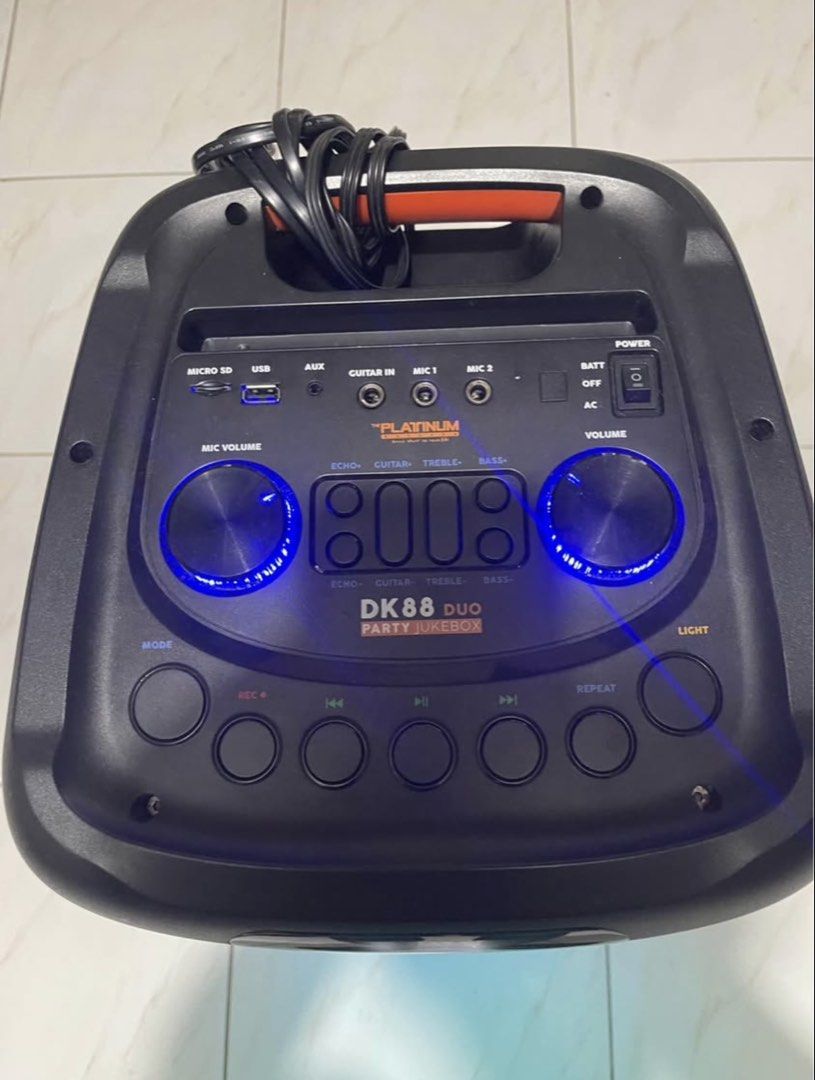 The Platinum DK88 Duo Party Jukebox Speaker (Category: Soundbars, Speakers & Amplifiers) located in San Pablo. Submitted by chamgyup__ (Listing ID 1448910441, Image 2). Description: - Platinum DK88 Duo Party Jukebox - Built-in Karaoke with over 21,000 English songs - Wireless Music Streaming - Includes 2 UHF Wireless Microphones - Features Fire Lighting Effects - 5 Hours Playing Time - Powerful 2000W PMPO Sound - Connectivity: Micro SD, USB, AUX 