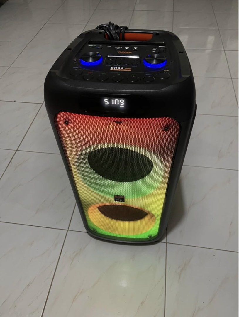 The Platinum DK88 Duo Party Jukebox Speaker (Category: Soundbars, Speakers & Amplifiers) located in San Pablo. Submitted by chamgyup__ (Listing ID 1448910441, Image 3). Description: - Platinum DK88 Duo Party Jukebox - Built-in Karaoke with over 21,000 English songs - Wireless Music Streaming - Includes 2 UHF Wireless Microphones - Features Fire Lighting Effects - 5 Hours Playing Time - Powerful 2000W PMPO Sound - Connectivity: Micro SD, USB, AUX 