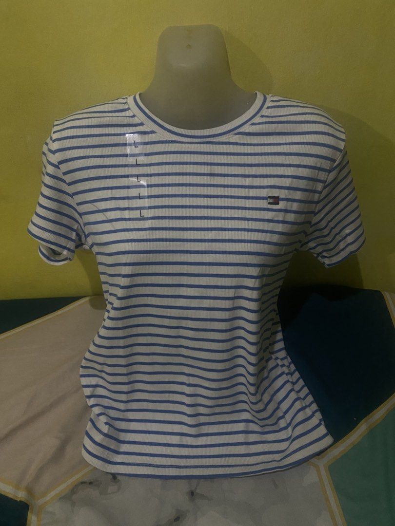 Tommy Hilfiger Striped T-Shirt (Category: Shirts) located in Cavite. Submitted by Abril_07 (Listing ID 1448926945, Image 2). Description: - Classic blue and white striped t-shirt - Brand: Tommy Hilfiger - Features ribbed texture - Small logo detail on the chest - Versatile staple piece for any wardrobe.