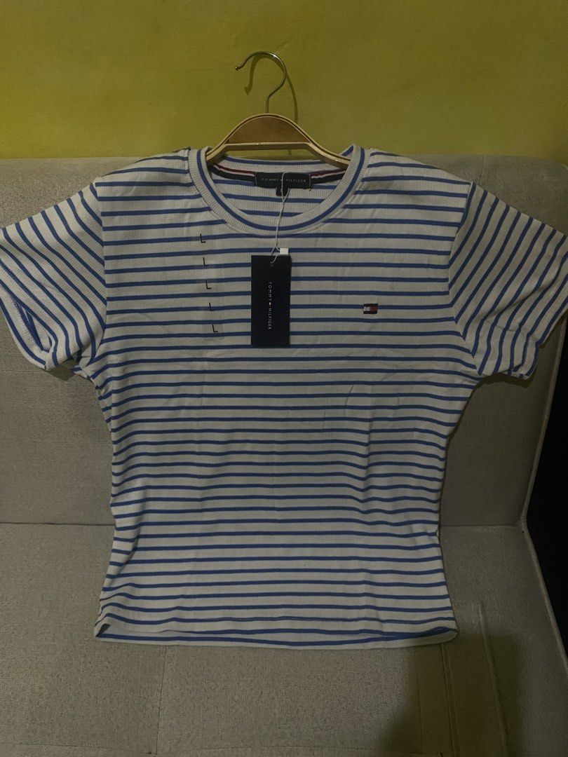 Tommy Hilfiger Striped T-Shirt (Category: Shirts) located in Cavite. Submitted by Abril_07 (Listing ID 1448926945, Image 3). Description: - Classic blue and white striped t-shirt - Brand: Tommy Hilfiger - Features ribbed texture - Small logo detail on the chest - Versatile staple piece for any wardrobe.