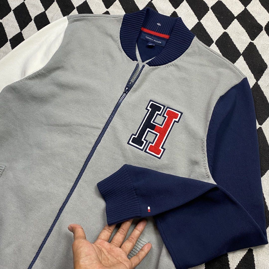 Tommy Hilfiger Varsity Bomber Jacket Grey Navy White Size M (Category: Coats, Jackets and Outerwear) located in Cebu City. Submitted by theloose.thread (Listing ID 1449074401, Image 2). Description: - Tommy Hilfiger Varsity Bomber Jacket - Color: Grey body with navy and white sleeves - Features Tommy Hilfiger 'H' logo on chest - Ribbed collar, cuffs, and hem - Zipper closure - Size: Medium (M) - Made in China.