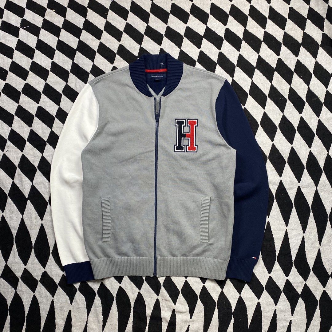 Tommy Hilfiger Varsity Bomber Jacket Grey Navy White Size M (Category: Coats, Jackets and Outerwear) located in Cebu City. Submitted by theloose.thread (Listing ID 1449074401, Image 1). Description: - Tommy Hilfiger Varsity Bomber Jacket - Color: Grey body with navy and white sleeves - Features Tommy Hilfiger 'H' logo on chest - Ribbed collar, cuffs, and hem - Zipper closure - Size: Medium (M) - Made in China.