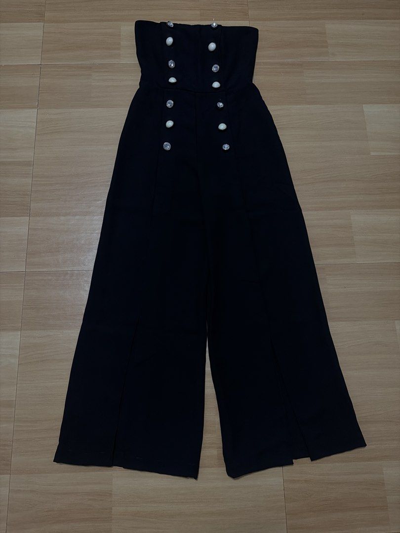 Topshop Strapless Wide Leg Jumpsuit (Category: Jumpsuits) located in Manila. Submitted by heypreloved2016 (Listing ID 1448930099, Image 1). Description: - Elegant black strapless jumpsuit - Flattering wide-leg pants with leg slits - Decorative button detailing down the front - Ideal for a night out or special occasions - Combines comfort and style.
