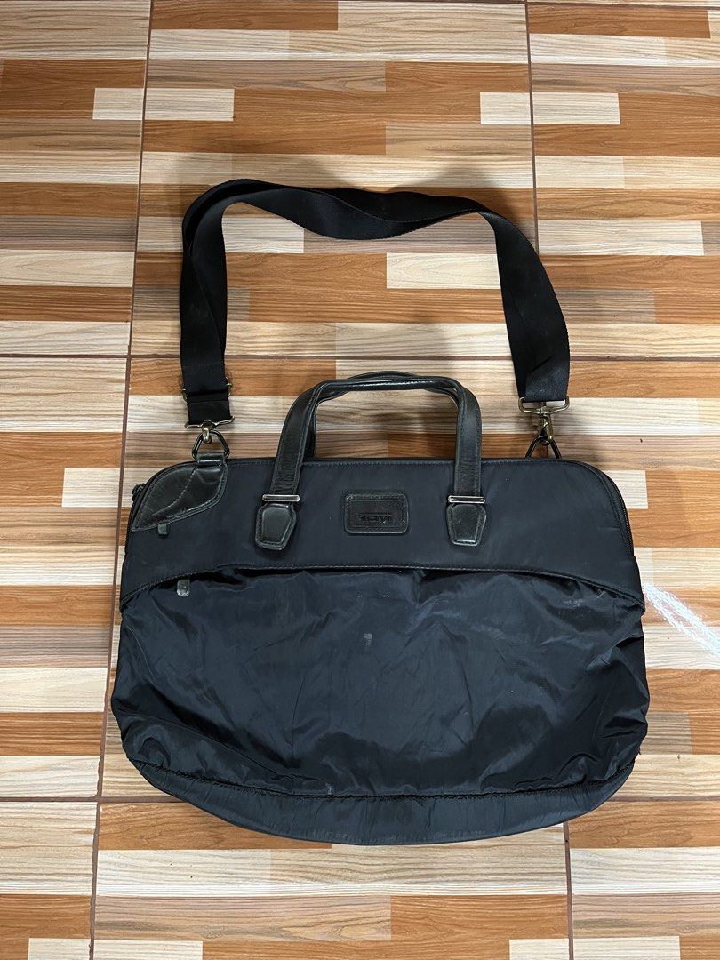 Tumi Black Nylon Leather Briefcase Laptop Bag (Category: Briefcases) located in Nabua. Submitted by lastthrift2.0 (Listing ID 1449017935, Image 2). Description: - Brand: Tumi - Color: Black - Material: Nylon with leather accents - Features: Detachable shoulder strap, spacious main compartment, front zip pocket for quick access - Ideal for: Work, travel, carrying laptops and essentials - Condition: Good, with some signs of wear.
