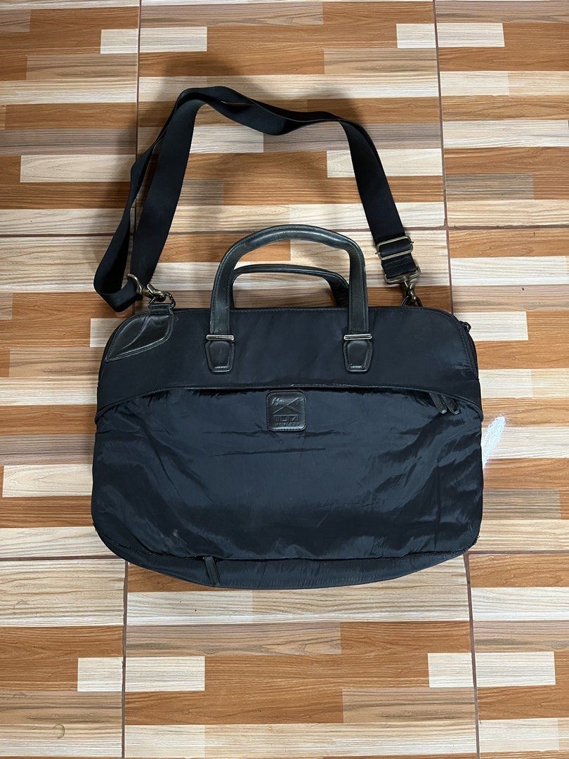 Tumi Black Nylon Leather Briefcase Laptop Bag (Category: Briefcases) located in Nabua. Submitted by lastthrift2.0 (Listing ID 1449017935, Image 1). Description: - Brand: Tumi - Color: Black - Material: Nylon with leather accents - Features: Detachable shoulder strap, spacious main compartment, front zip pocket for quick access - Ideal for: Work, travel, carrying laptops and essentials - Condition: Good, with some signs of wear.