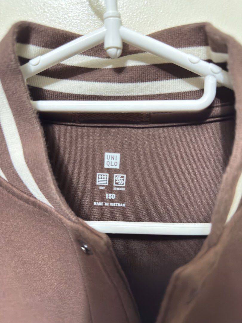 UNIQLO Brown Varsity Jacket (Category: Coats, Jackets and Outerwear) located in Quezon City. Submitted by weeklydeclutter (Listing ID 1448979222, Image 3). Description: - Uniqlo Brown Varsity Jacket - White Sleeves - Striped Collar, Cuffs, and Hem - 'H' Patch on Chest - Made in Vietnam - Ideal for Everyday Wear L- 22 w-18.