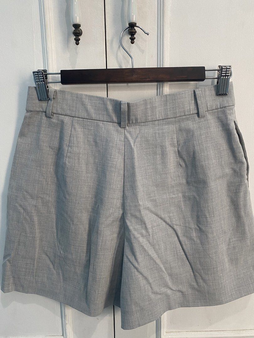 Uniqlo Gray Smart Shorts (Category: Shorts) located in Makati City. Submitted by declutterteacher (Listing ID 1448927820, Image 2). Description: - Uniqlo Grey Pleated Shorts - Material: Polyester, Rayon, Spandex blend - Closure: Zip and button - Condition: Dark stains on front left leg (please check photos) - Measurements: Waist 63-69cm, Hip 88-94cm - Fits S-M.