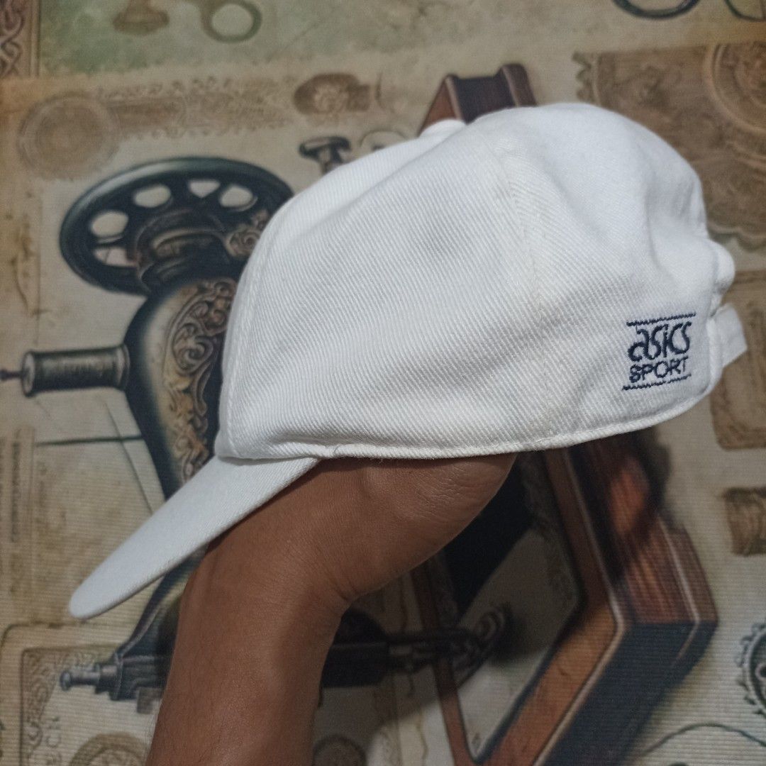 Vintage Asics Sport White Baseball Cap (Category: Caps & Hats) located in Zaragoza. Submitted by jeromegami62825 (Listing ID 1448999650, Image 2). Description: - Classic white Asics sport cap - Simple and timeless design - Features embroidered Asics logo on the front - Adjustable strap at the back for a customized fit - Perfect for everyday wear or athletic activities.
