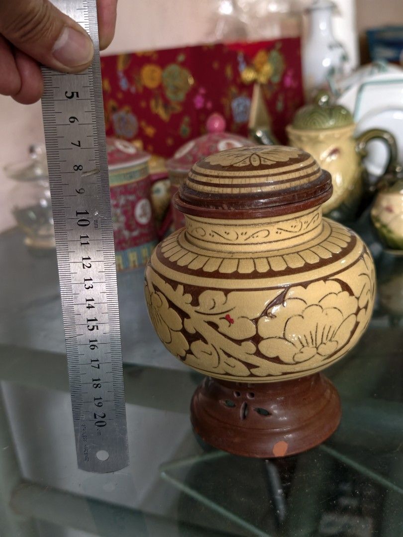 Vintage Wooden Jar with Lid and Stand (Category: Vases & Decorative Bowls) located in Puchong. Submitted by briandeal (Listing ID 1449018518, Image 3). Description: - Intricately carved small wooden jar - Includes matching lid and decorative stand - Light yellow wood with dark brown painted details - Approximately 15cm tall (with lid) - Ideal for display or storing small trinkets.