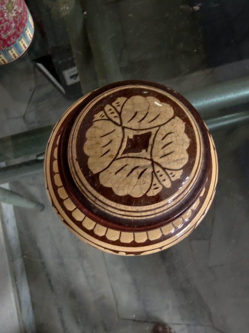 Vintage Wooden Jar with Lid and Stand (Category: Vases & Decorative Bowls) located in Puchong. Submitted by briandeal (Listing ID 1449018518, Image 2). Description: - Intricately carved small wooden jar - Includes matching lid and decorative stand - Light yellow wood with dark brown painted details - Approximately 15cm tall (with lid) - Ideal for display or storing small trinkets.