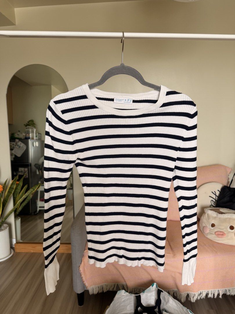 White and Navy Striped Long Sleeve Sweater (Category: Longsleeves) located in Manila. Submitted by elliechan29 (Listing ID 1448972285, Image 1). Description: - Classic white and navy striped long sleeve sweater. - Cozy ribbed knit fabric for a snug fit. - Stylish flared sleeves at the cuff. - Cute lettuce edge detail on the hem. - Versatile for layering or wearing on its own. - Effortlessly pairs with jeans or skirts..
