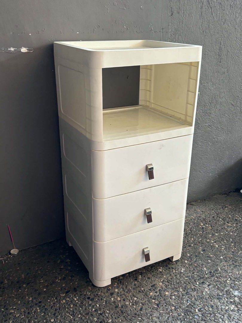 White Cabinet with Drawers (Category: Storage Boxes & Baskets) located in Quezon City. Submitted by tess1976 (Listing ID 1436715524, Image 3). Description: - White cabinet - 3 drawers - Open shelf - Silver handles with brown accents - Rounded design - Versatile storage solution.