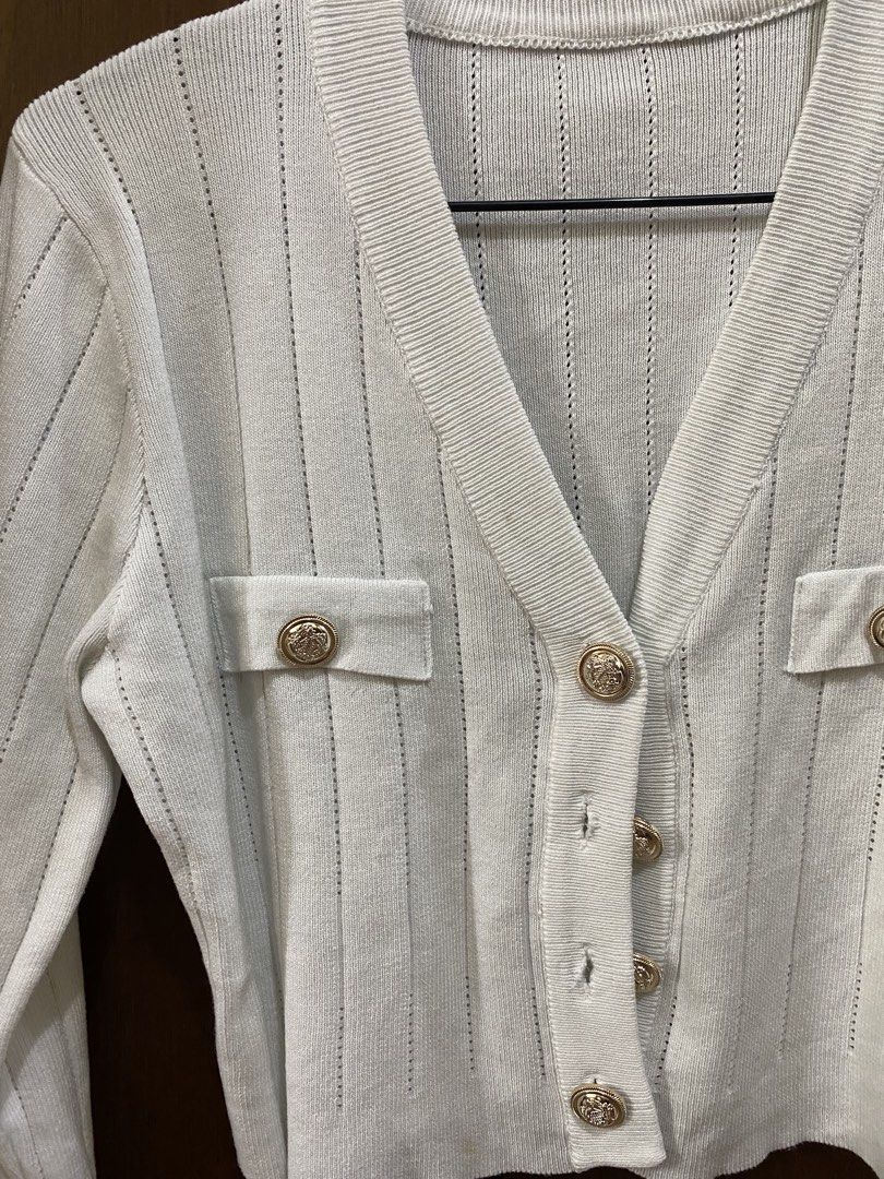 White Cropped Cardigan with Gold Buttons (Category: Coats, Jackets and Outerwear) located in Manila. Submitted by anneeem (Listing ID 1448994901, Image 3). Description: - White cropped cardigan - Long sleeves - V-neckline - Gold button details - Two faux pockets - Subtle textured knit pattern.