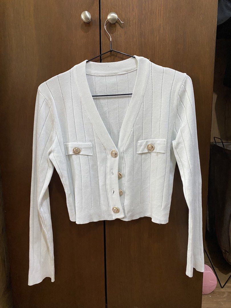 White Cropped Cardigan with Gold Buttons (Category: Coats, Jackets and Outerwear) located in Manila. Submitted by anneeem (Listing ID 1448994901, Image 1). Description: - White cropped cardigan - Long sleeves - V-neckline - Gold button details - Two faux pockets - Subtle textured knit pattern.