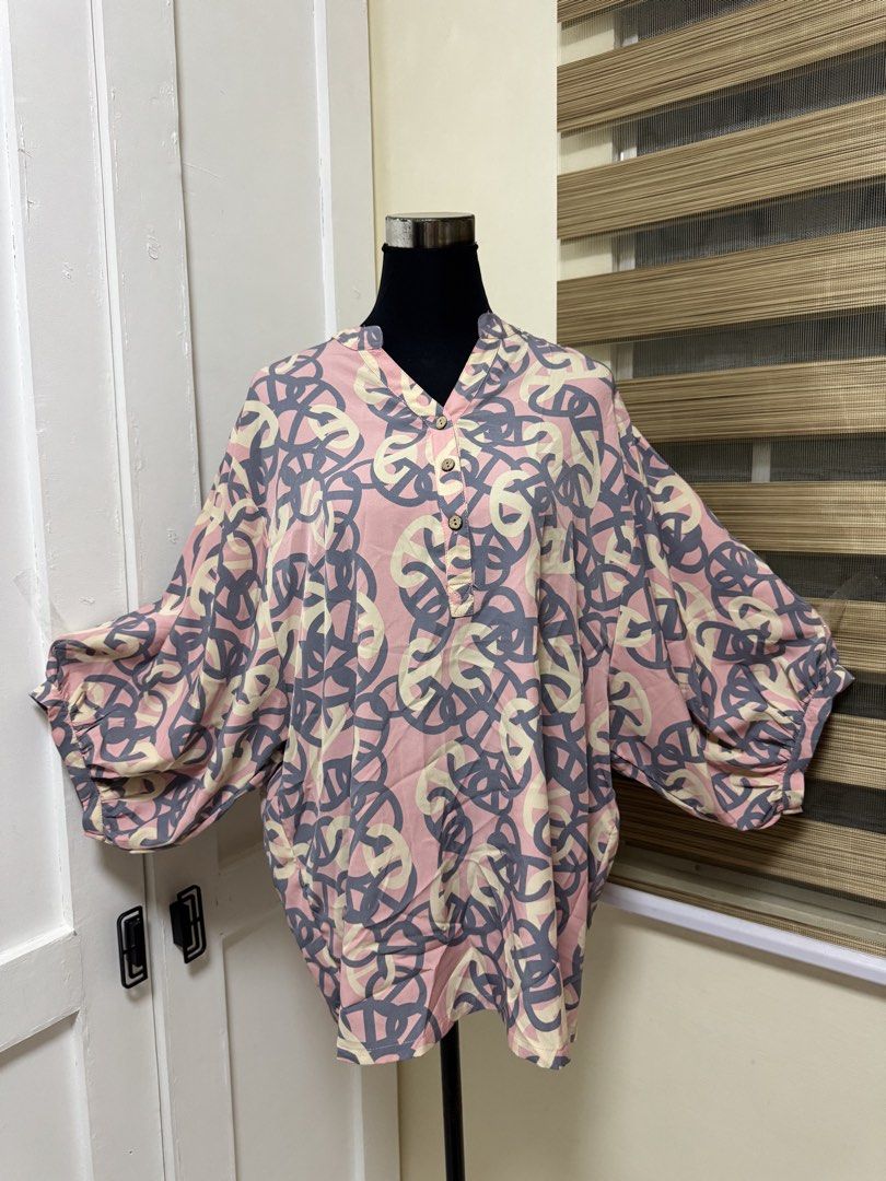 Woman Plus Size 4L Pink Grey Patterned Blouse preloved (Category: Blouses) located in Manila. Submitted by milleshoppppp (Listing ID 1449078834, Image 1). Description: - Oversized blouse with unique abstract print (pink, grey, cream) - V-neckline with button details - Voluminous balloon sleeves with elastic cuffs - Lightweight and flowy fabric - Perfect for a stylish casual look.