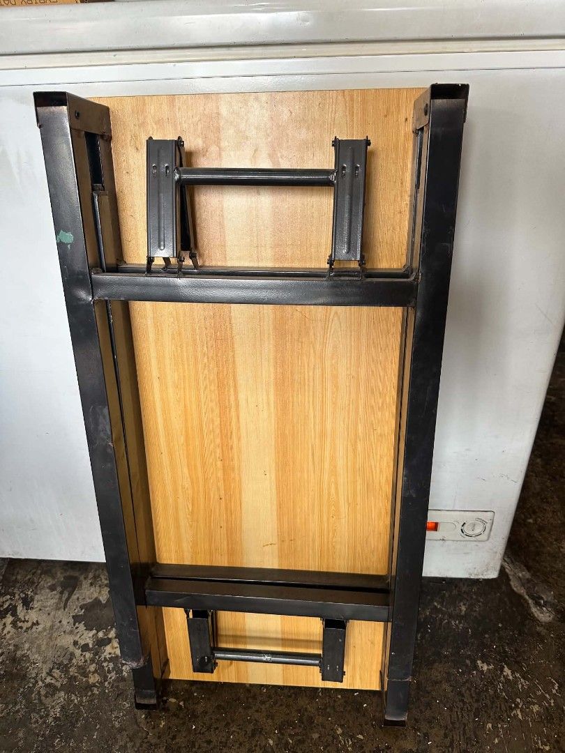 Wooden Folding Table with Metal Legs (Category: Tables & Sets) located in Manila. Submitted by gtrrzz12213094 (Listing ID 1448996304, Image 2). Description: - Compact folding table - Wood grain top - Sturdy black metal legs - Folds flat for easy storage - Ideal for small spaces, picnics, or as an extra surface - Lightweight and portable.