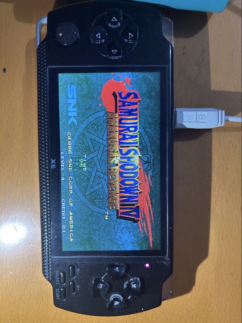 X6 Handheld Game Console with Retro Games (Category: Others) located in Paranaque City. Submitted by zac.sei (Listing ID 1448982835, Image 3). Description: used but in very good condition includes charging wire - Portable X6 handheld game console - Pre-loaded with classic games: Metal Slug, Samurai Shodown, Mega Man 2, and more! - Ideal for gaming on the go - Features a clear screen and responsive buttons - Charging cable included - Ready for hou