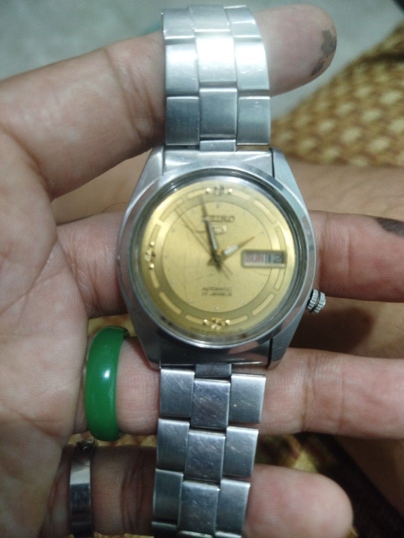 1980s Seiko 5 Automatic Gold Dial Men's Watch (Category: Men's Watches) located in Subic. Submitted by regiedaniel01 (Listing ID 1449158949, Image 1). Description: - Classic Seiko 5 Automatic Watch - Elegant Gold Dial with Day & Date Display - Durable Stainless Steel Bracelet - Reliable Automatic Movement - Works Well - Shows Minor Signs of Wear on Case & Bracelet - Ideal for Everyday Wear - issue : may mga scratchess sa glass and napalitan na an