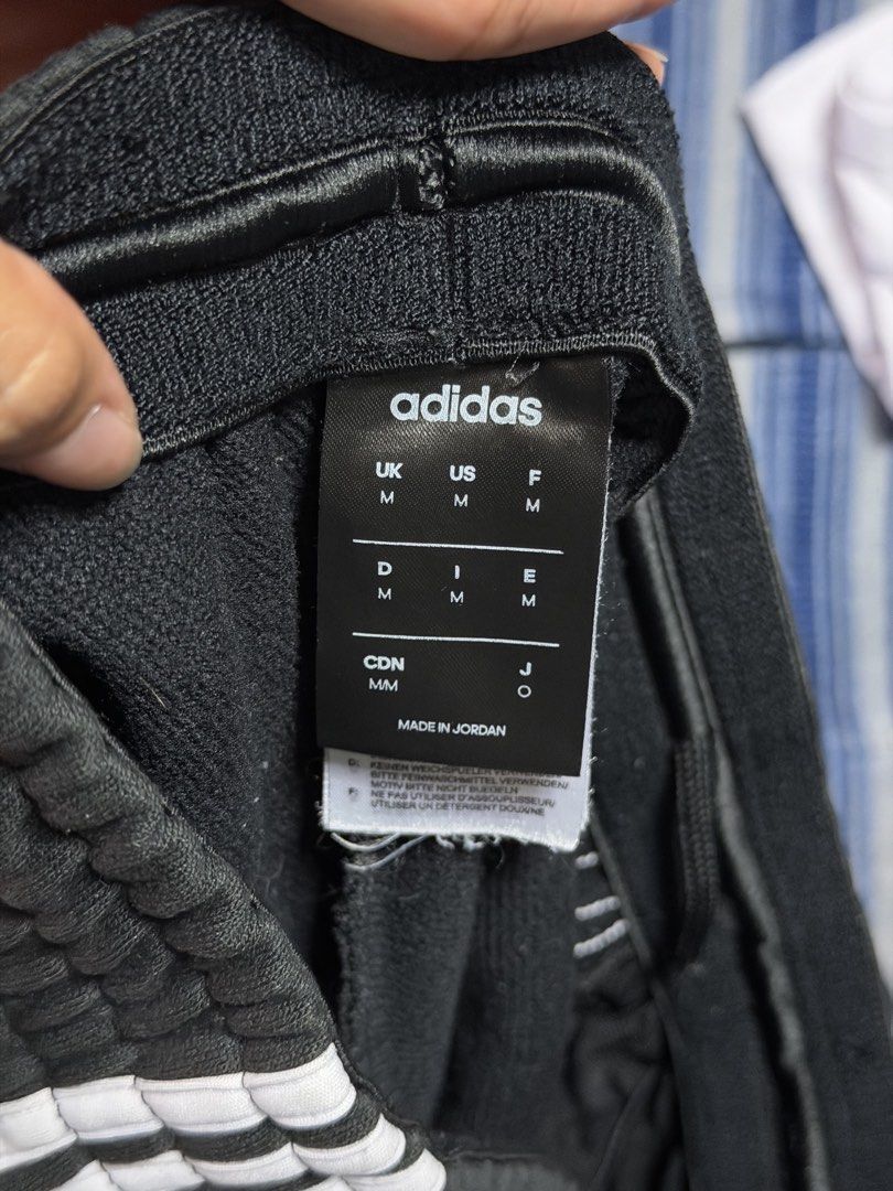 Adidas Black Track Pants with White Stripes - Size Medium (Category: Activewear) located in Manila. Submitted by payjo27 (Listing ID 1449134173, Image 2). Description: - unisex adidas track pants - medium on tag 📍Pasig City.